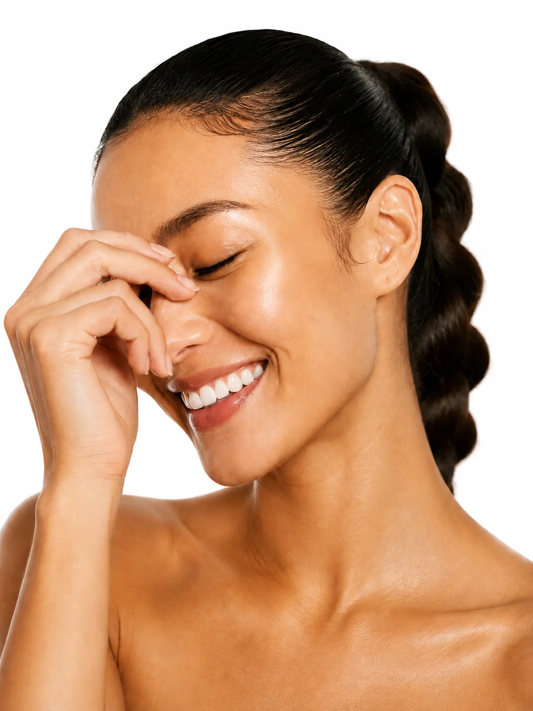 Woman with sleek wavy hair smiling in soft light
