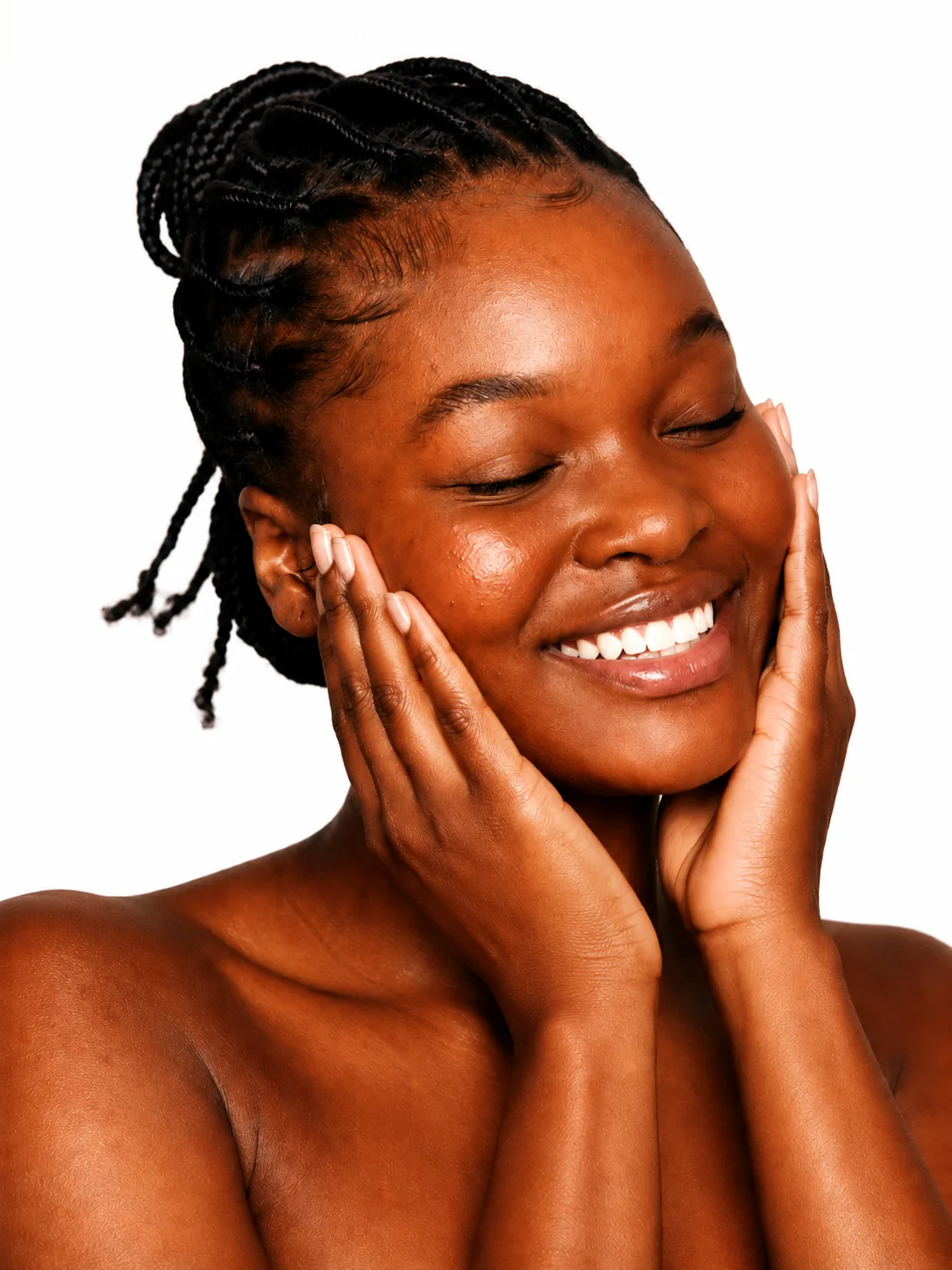 Woman with curly, coily, and kinky hair smiling with glowing skin